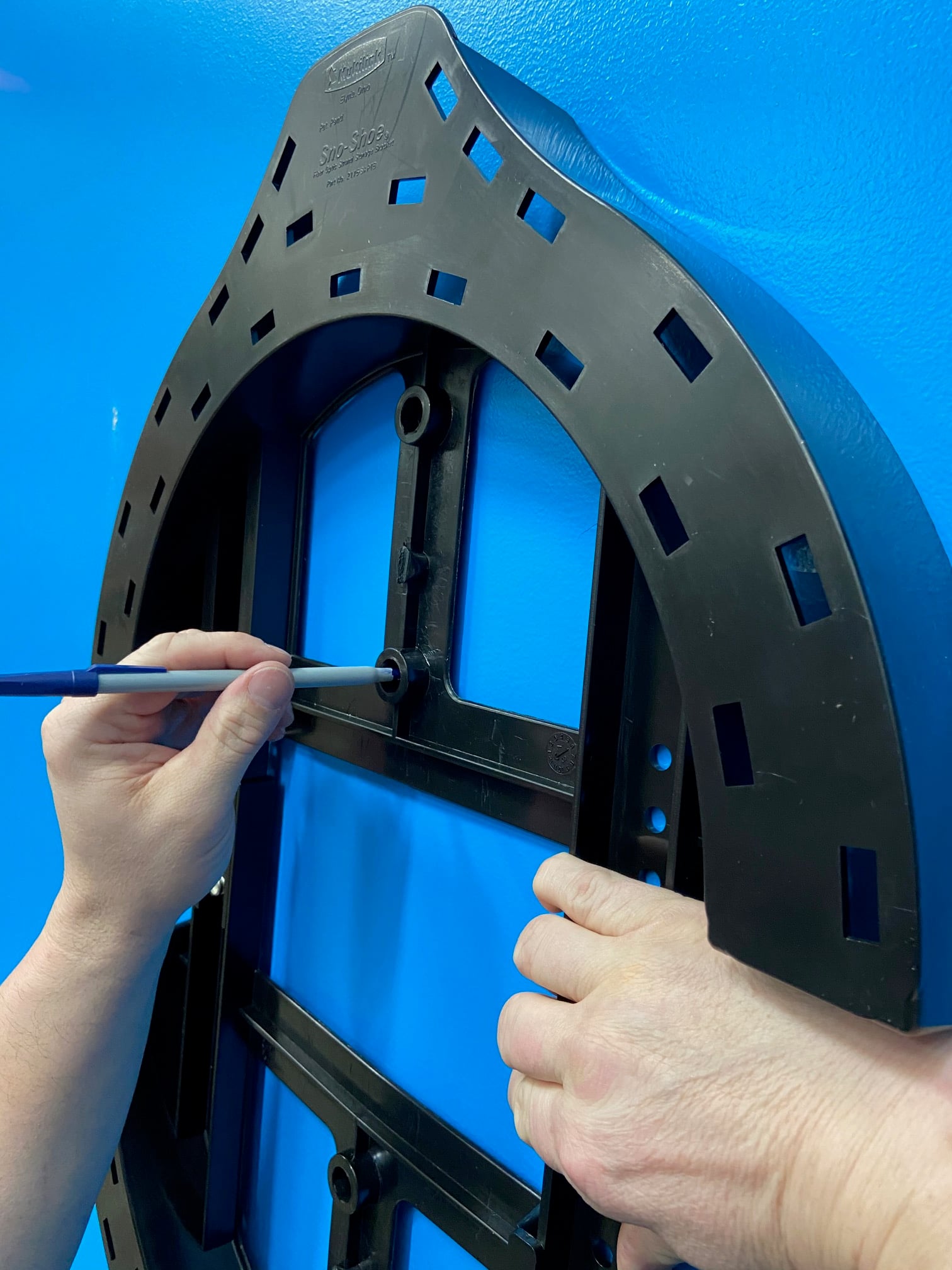 Close-up of fiber sno-shoe installation showing slack storage mounting for aerial fiber optic cable